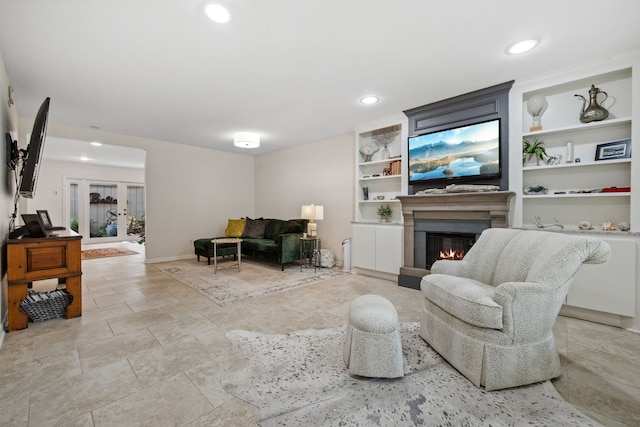 5859 Doliver Dr Unit 14, Houston, TX 77057 - living room featuring a lit fireplace, built in shelves, recessed lighting, and light stone finish flooring