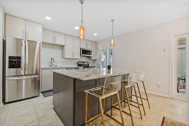 5859 Doliver Dr Unit 14, Houston, TX 77057 - kitchen with appliances with stainless steel finishes, light tile patterned flooring, a sink, white cabinets, and recessed lighting