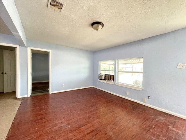 3707 Rosemont St, Houston, TX 77051 - unfurnished room featuring a textured ceiling, wood finished floors, baseboards, and cooling unit