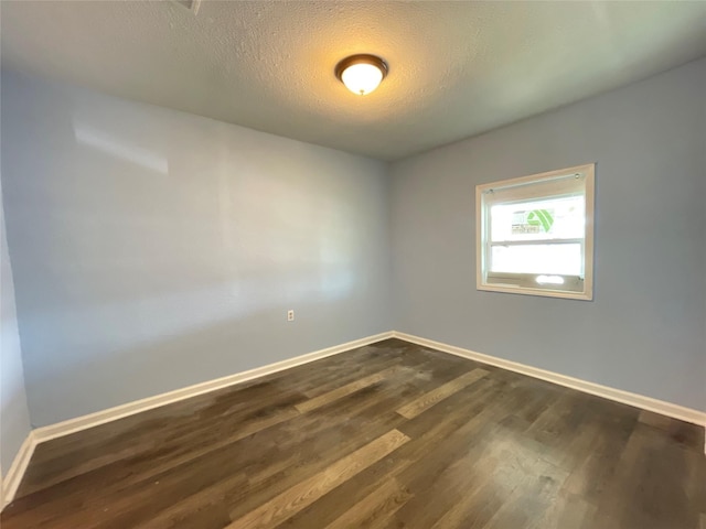 3707 Rosemont St, Houston, TX 77051 - spare room featuring baseboards, dark wood finished floors, and a textured ceiling