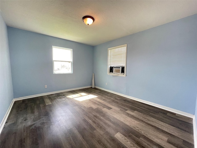3707 Rosemont St, Houston, TX 77051 - spare room with dark wood-style flooring, cooling unit, baseboards, and a textured ceiling