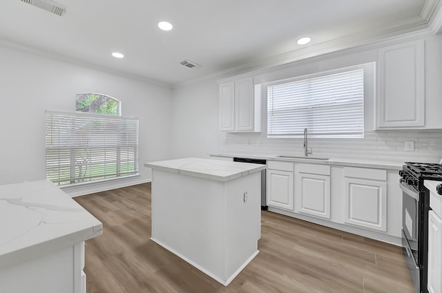 2918 Linda Dr, Pearland, TX 77584 - kitchen featuring a sink, dishwasher, crown molding, backsplash, and black gas range