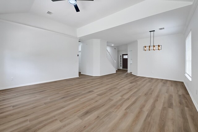 2918 Linda Dr, Pearland, TX 77584 - unfurnished living room with a ceiling fan, light wood-style flooring, stairs, baseboards, and vaulted ceiling