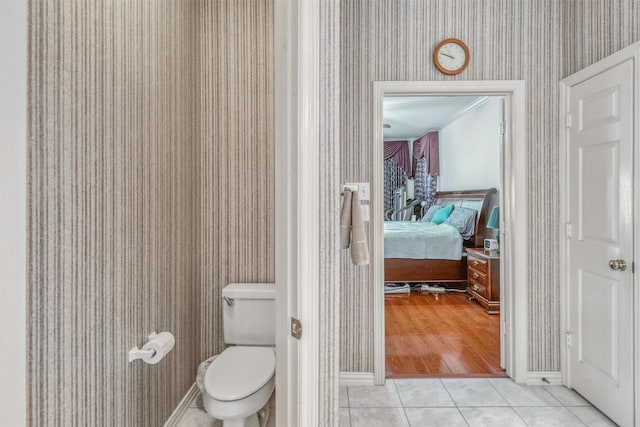 23207 Greenrush Dr, Katy, TX 77494 - ensuite bathroom with wallpapered walls, tile patterned floors, and toilet