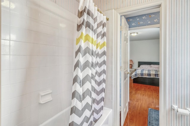 23207 Greenrush Dr, Katy, TX 77494 - ensuite bathroom with wallpapered walls, wood finished floors, and shower / bath combination with curtain