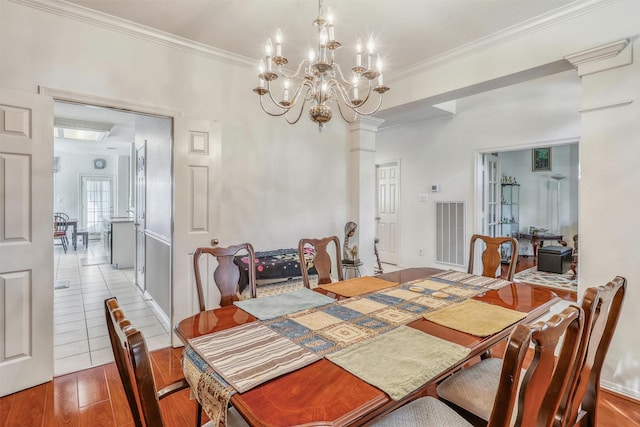 23207 Greenrush Dr, Katy, TX 77494 - dining space featuring wood finished floors, a chandelier, and crown molding