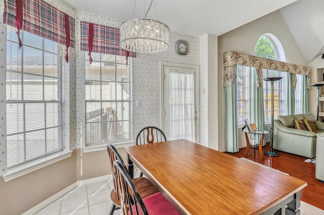 23207 Greenrush Dr, Katy, TX 77494 - tiled dining area featuring a chandelier, vaulted ceiling, and baseboards
