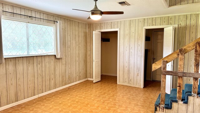 430 Hooks Rd, Livingston, TX 77351 - unfurnished bedroom featuring wooden walls and ceiling fan