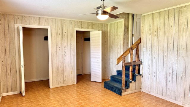 430 Hooks Rd, Livingston, TX 77351 - interior space featuring ceiling fan, stairs, wood walls, and ornamental molding