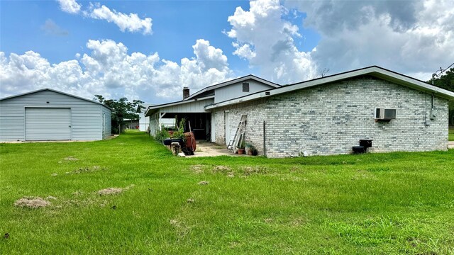 430 Hooks Rd, Livingston, TX 77351 - view of property exterior featuring a yard, an outdoor structure, a garage, and brick siding