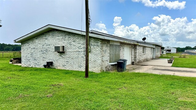 430 Hooks Rd, Livingston, TX 77351 - view of side of property with brick siding, a patio, and a wall mounted air conditioner