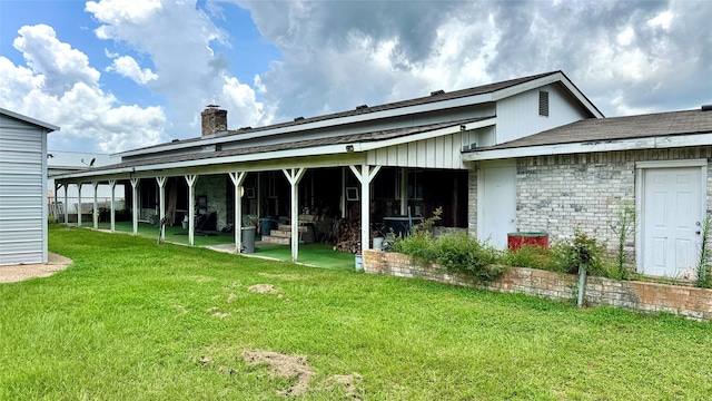 430 Hooks Rd, Livingston, TX 77351 - back of house featuring a chimney and a yard