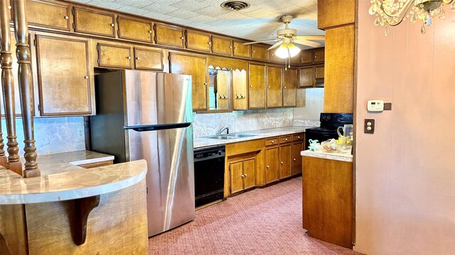 430 Hooks Rd, Livingston, TX 77351 - kitchen with black appliances, brown cabinets, ceiling fan, and light countertops
