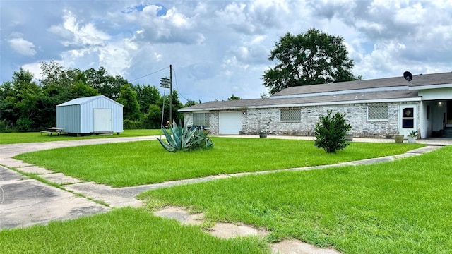 430 Hooks Rd, Livingston, TX 77351 - view of grassy yard featuring an attached garage, a storage unit, and driveway