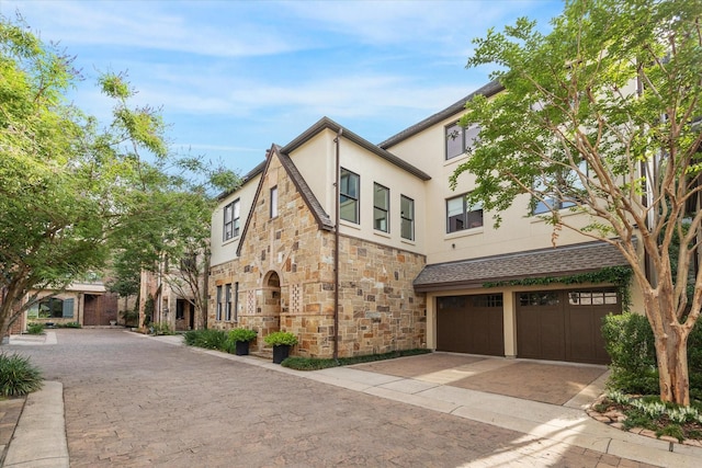 1647 Bissonnet St, Houston, TX 77005 - view of front of house featuring stone siding, stucco siding, an attached garage, and decorative driveway