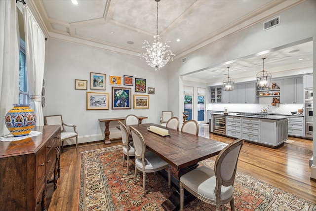 1647 Bissonnet St, Houston, TX 77005 - dining area with wine cooler, hardwood / wood-style flooring, baseboards, ornamental molding, and recessed lighting