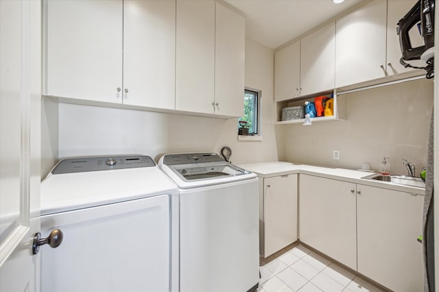 1647 Bissonnet St, Houston, TX 77005 - laundry room featuring cabinet space, washer and dryer, and light tile patterned floors