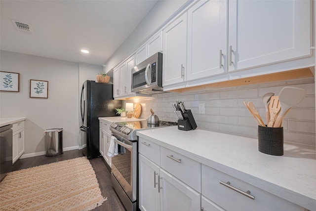 14688 Perthshire Rd Unit C, Houston, TX 77079 - kitchen with stainless steel appliances, white cabinetry, light countertops, decorative backsplash, and baseboards