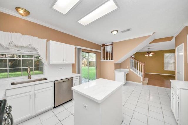 4907 Heritage Plains Dr, Friendswood, TX 77546 - kitchen featuring stainless steel appliances, a sink, a center island, light tile patterned floors, and ornamental molding