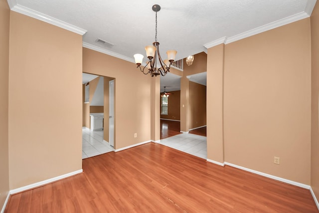 4907 Heritage Plains Dr, Friendswood, TX 77546 - empty room with wood finished floors, a chandelier, baseboards, ornamental molding, and a ceiling fan