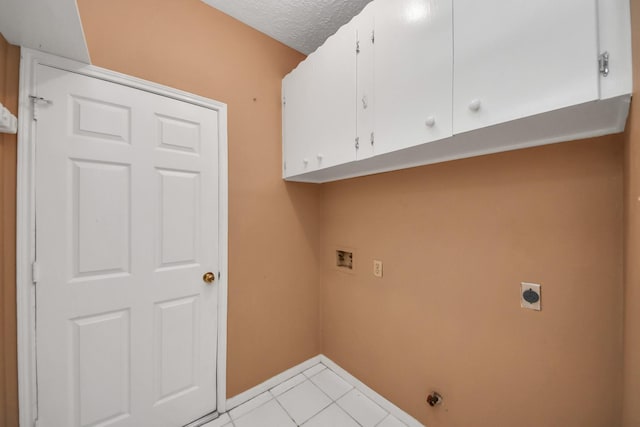 4907 Heritage Plains Dr, Friendswood, TX 77546 - laundry room featuring electric dryer hookup, cabinet space, hookup for a washing machine, baseboards, and light tile patterned floors