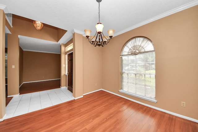 4907 Heritage Plains Dr, Friendswood, TX 77546 - empty room with a chandelier, wood finished floors, ornamental molding, and baseboards