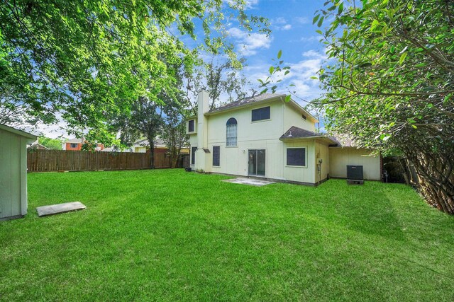 4907 Heritage Plains Dr, Friendswood, TX 77546 - back of property featuring cooling unit and a chimney