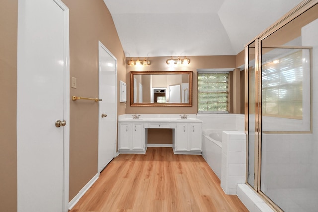 4907 Heritage Plains Dr, Friendswood, TX 77546 - full bath with wood finished floors, double vanity, a bath, a shower stall, and lofted ceiling