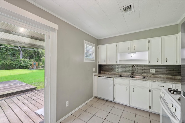 9270 Mclean St, Beaumont, TX 77707 - kitchen with white appliances, a sink, backsplash, white cabinets, and crown molding