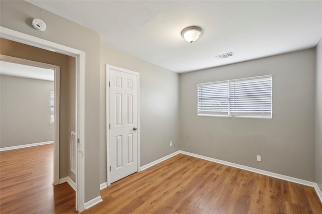 9270 Mclean St, Beaumont, TX 77707 - empty room with wood finished floors, a smoke detector, and baseboards