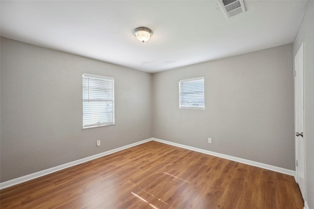 9270 Mclean St, Beaumont, TX 77707 - unfurnished room featuring healthy amount of natural light, wood finished floors, and baseboards