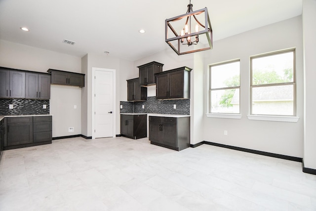 208 Silverleaf Rd, Sweeny, TX 77480 - kitchen featuring backsplash, a chandelier, light countertops, hanging light fixtures, and baseboards