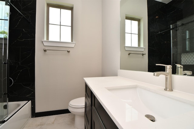 208 Silverleaf Rd, Sweeny, TX 77480 - bathroom featuring vanity, toilet, a combined bath / shower with marble appearance, tile patterned floors, and baseboards