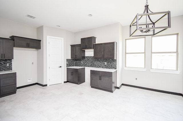 208 Silverleaf Rd, Sweeny, TX 77480 - kitchen featuring tasteful backsplash, dark brown cabinets, baseboards, decorative light fixtures, and light countertops