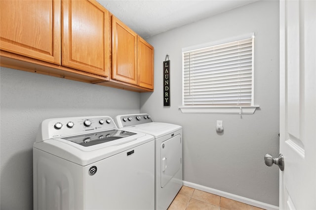 7818 Palm Brook Ct, Houston, TX 77095 - washroom with cabinet space, washer and dryer, baseboards, and light tile patterned floors