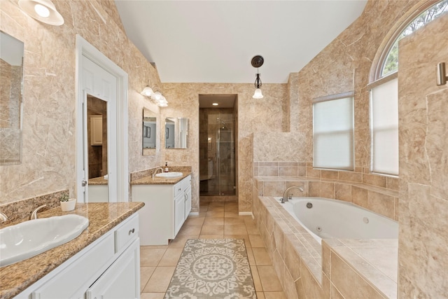 7818 Palm Brook Ct, Houston, TX 77095 - bathroom featuring a stall shower, two vanities, a whirlpool tub, tile patterned floors, and tile walls