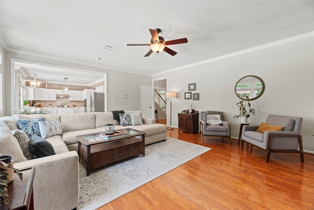 7818 Palm Brook Ct, Houston, TX 77095 - living area featuring ceiling fan, light wood-type flooring, stairs, and ornamental molding