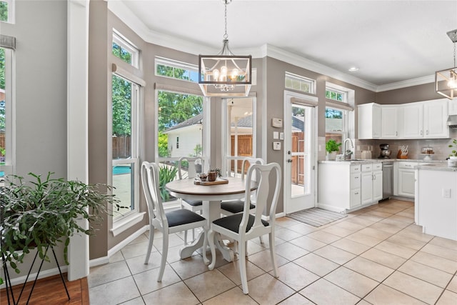 7818 Palm Brook Ct, Houston, TX 77095 - dining area with a chandelier, ornamental molding, light tile patterned flooring, healthy amount of natural light, and baseboards
