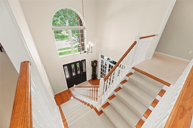 7818 Palm Brook Ct, Houston, TX 77095 - foyer entrance featuring a chandelier, a high ceiling, stairway, wood finished floors, and baseboards