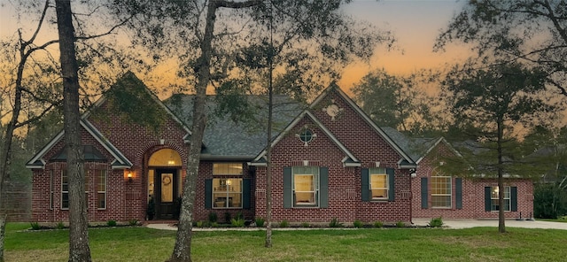 28511 E Benders Landing Blvd, Spring, TX 77386 - view of front facade featuring a front lawn, a shingled roof, and brick siding