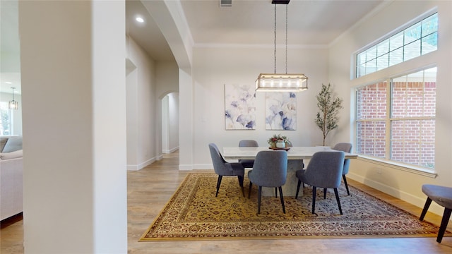 28511 E Benders Landing Blvd, Spring, TX 77386 - dining room with arched walkways, crown molding, wood finished floors, and baseboards