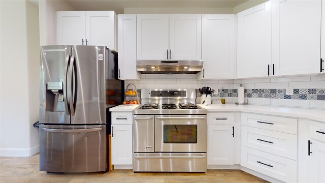 28511 E Benders Landing Blvd, Spring, TX 77386 - kitchen with stainless steel appliances, under cabinet range hood, tasteful backsplash, and white cabinetry
