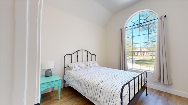 28511 E Benders Landing Blvd, Spring, TX 77386 - bedroom with multiple windows, baseboards, wood finished floors, and lofted ceiling