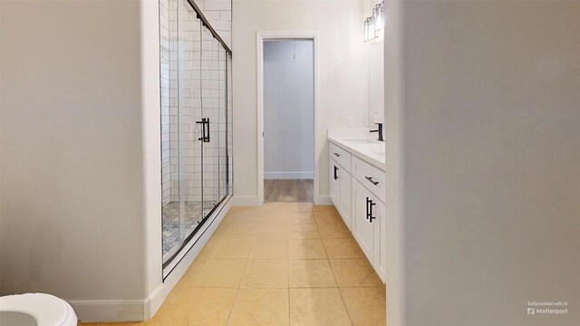 28511 E Benders Landing Blvd, Spring, TX 77386 - bathroom featuring a shower stall, vanity, tile patterned flooring, and baseboards
