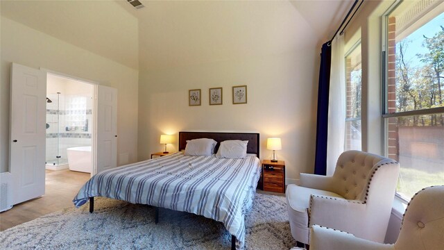 28511 E Benders Landing Blvd, Spring, TX 77386 - bedroom featuring lofted ceiling, wood finished floors, and ensuite bathroom
