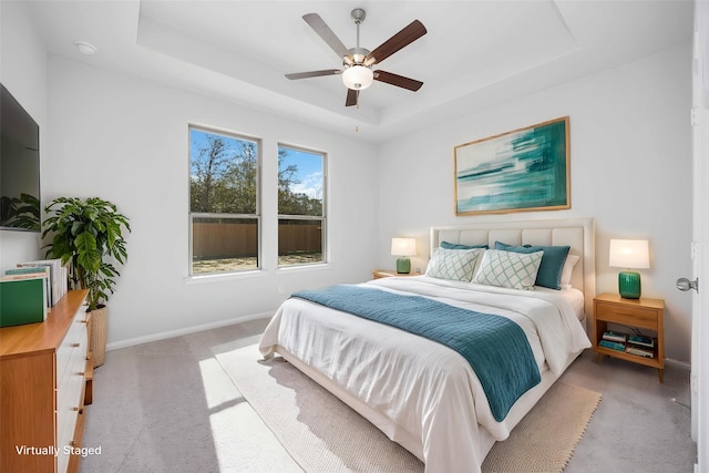 1039 Lilly Ln, Bellville, TX 77418 - bedroom with a raised ceiling, light carpet, baseboards, and ceiling fan