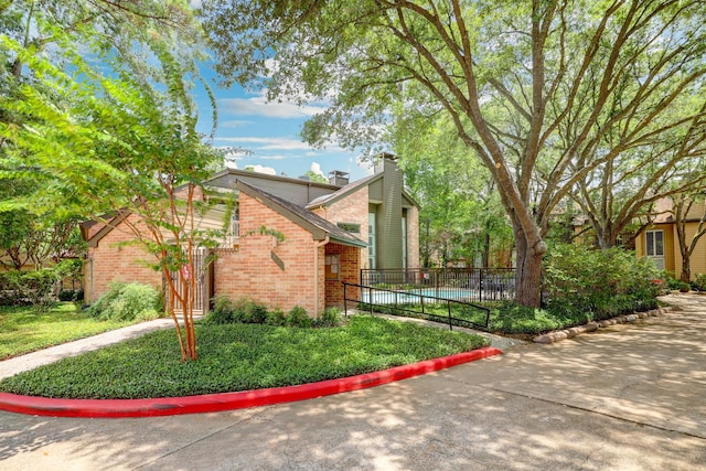 322 Sugarberry Cir, Houston, TX 77024 - view of side of home featuring brick siding and a chimney
