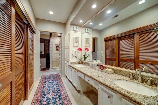 322 Sugarberry Cir, Houston, TX 77024 - full bathroom with a closet, a shower stall, double vanity, recessed lighting, and toilet