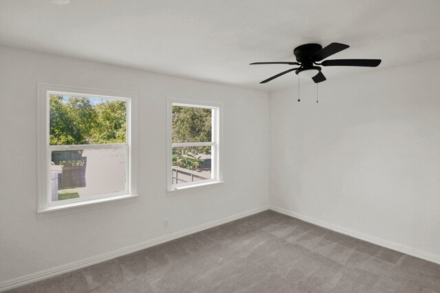 1101 2nd Ave N, Texas City, TX 77590 - carpeted spare room with baseboards and a ceiling fan
