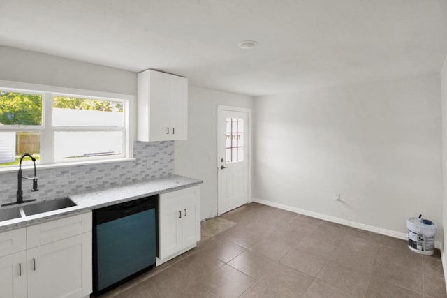 1101 2nd Ave N, Texas City, TX 77590 - kitchen featuring dishwashing machine, a sink, backsplash, white cabinets, and baseboards